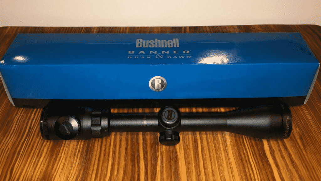 Bushnell Banner Dusk and Dawn budget 450 bushmaster scope with its box sitting on my dining room table.